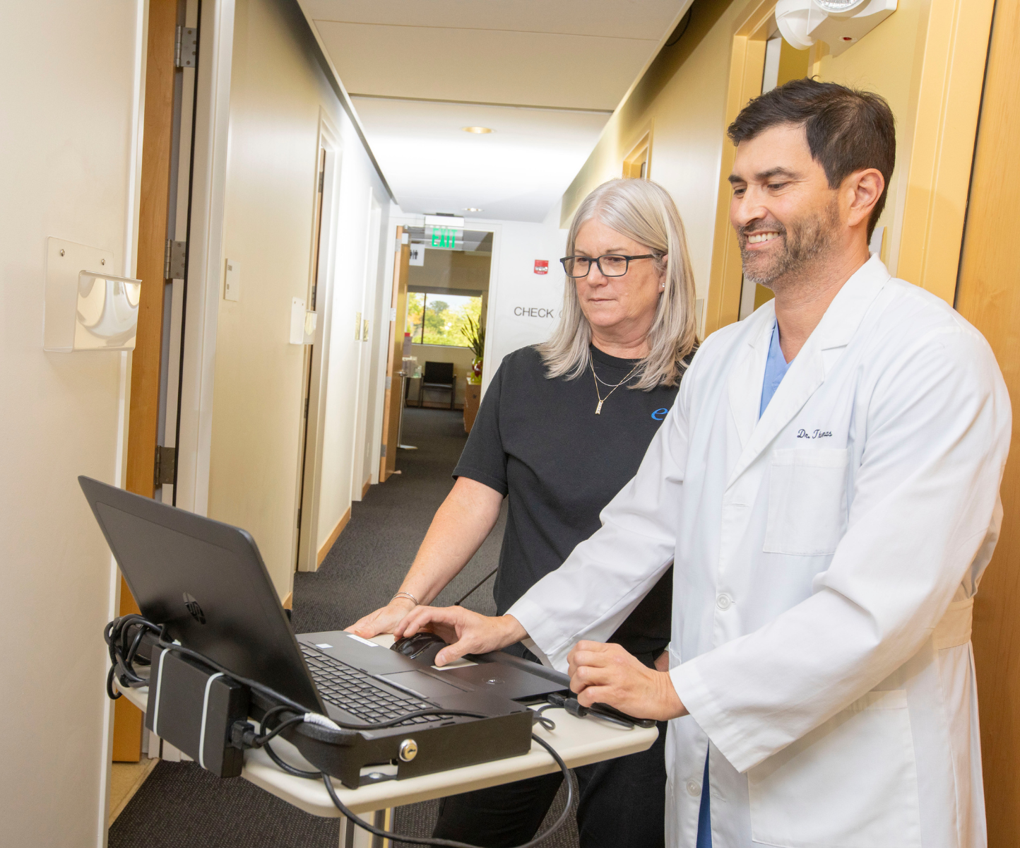 Doctor and Nurse on computer in a hallway
